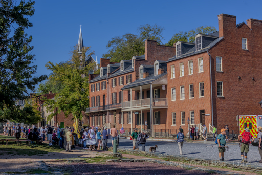 John Brown's fort, with protestors outside showing their oppostition to the erasure of history.  St Peters Catholic Church steeple rising in background.