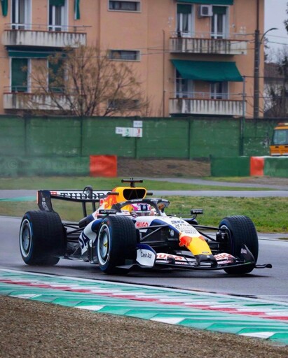 a VCARB Formula 1 racing car driving on a racing track