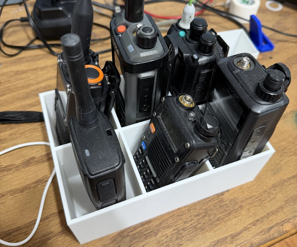 a bunch of walkie talkies in a 3d printed caddy